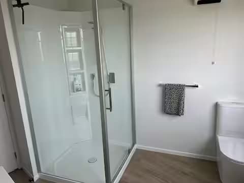 Compact bathroom shower and vanity