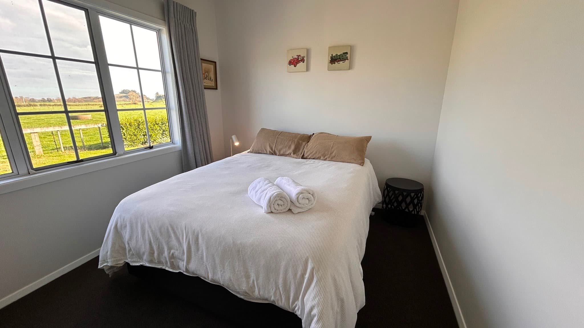 Queen bedroom with countryside view through the window