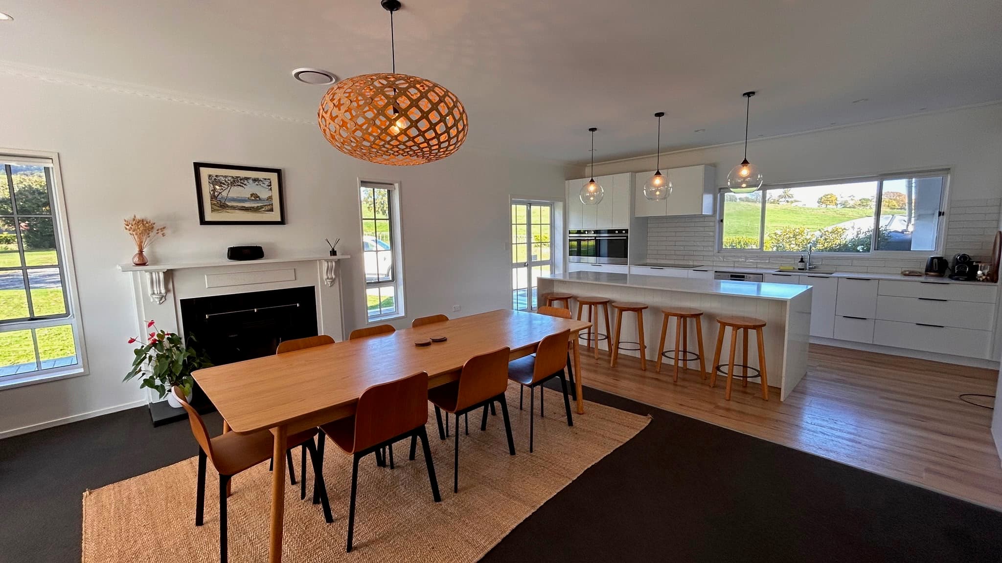 Open plan dining room and modern kitchen with rural views